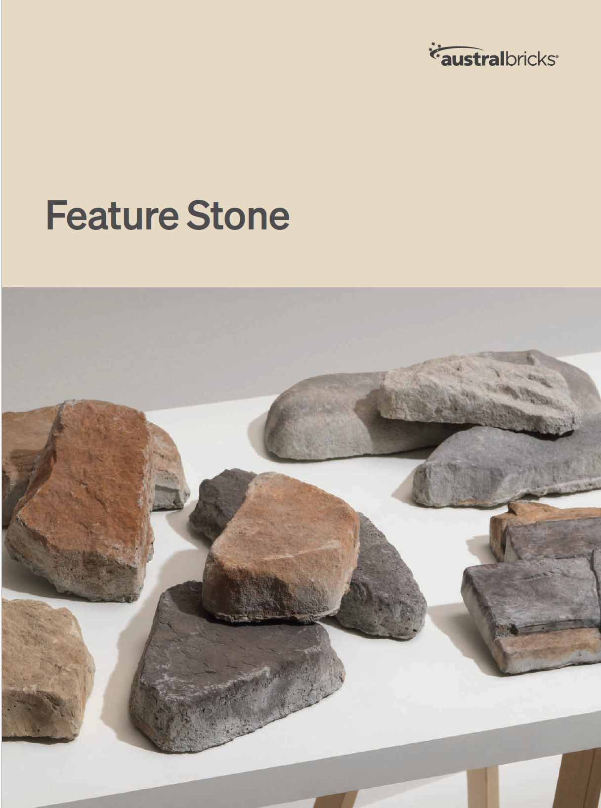 Austral Feature Stone Brochure Cover. Feature stone heading with samples of stone pieces on a white table