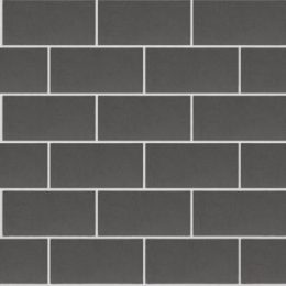 Image of a wall composed of uniformly arranged GB Smooth Pewter bricks in a horizontal pattern. The dark gray bricks have a smooth texture and are evenly spaced, creating a clean and modern appearance.