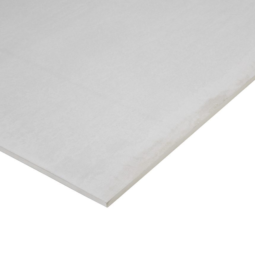 A close-up of the Duracom™ Compressed Façade, showcasing its smooth texture and subtle color variations along the edges. The flat, rectangular tile appears in a light gray tone against a plain white background.