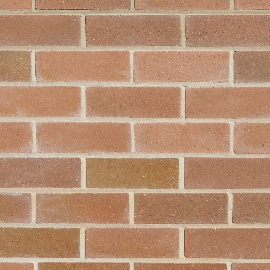 A close-up view of the Lincoln Ashfield Grey brick wall, featuring evenly spaced horizontal and vertical mortar lines that form a classic pattern reminiscent of historic architecture. The surface exhibits a slightly textured appearance with variations in grey tones.