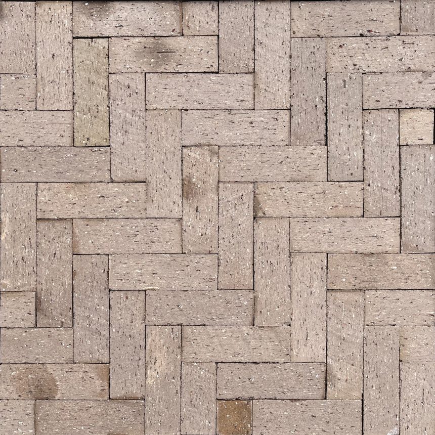 A close-up of a brick wall highlights a herringbone pattern with light brown bricks, enhanced by the Slim Ash product. Some bricks display slight color variations, adding texture and depth, while small dark spots punctuate the surface.