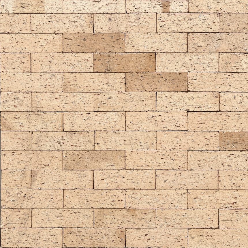A close-up of a beige paved area featuring the Slim Peninsula pattern showcases its sleek lines. The rectangular pavers are evenly arranged to create a uniform look, with subtle colour variations in some pavers adding texture to the surface.