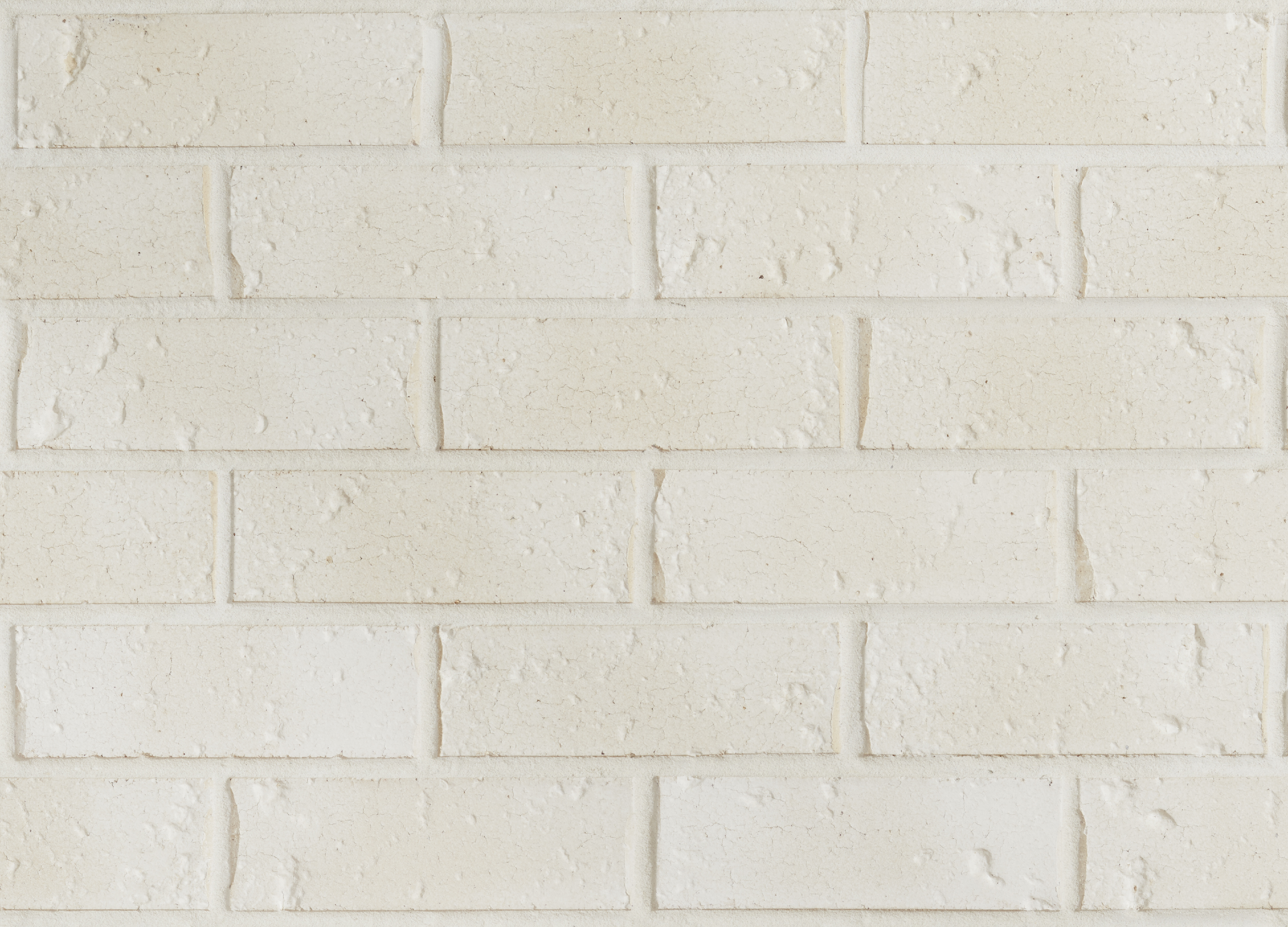 A close-up of the Coastal Hamptons Washed White wall showcases its rough texture, rectangular pattern, and subtle tonal variations in surface details.