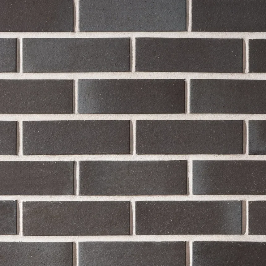 La Palomo Azul's rectangular dark grey bricks are arranged horizontally on the wall, highlighted by sharp white mortar lines.