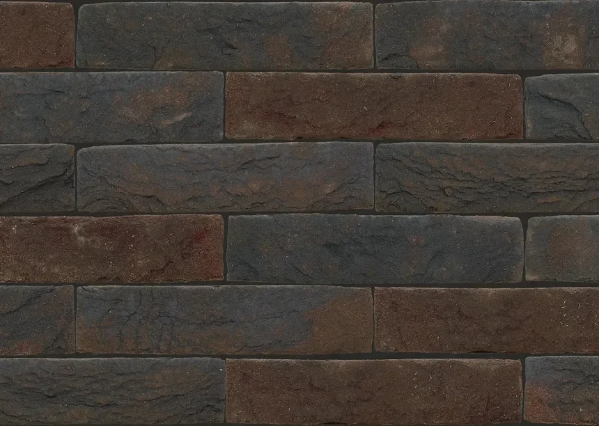 A close-up of a brick wall features Nelissen Ypres bricks, characterized by their rough texture and a blend of dark grey and reddish-brown colors, arranged in a horizontal pattern. The bricks exhibit a diverse, weathered look.