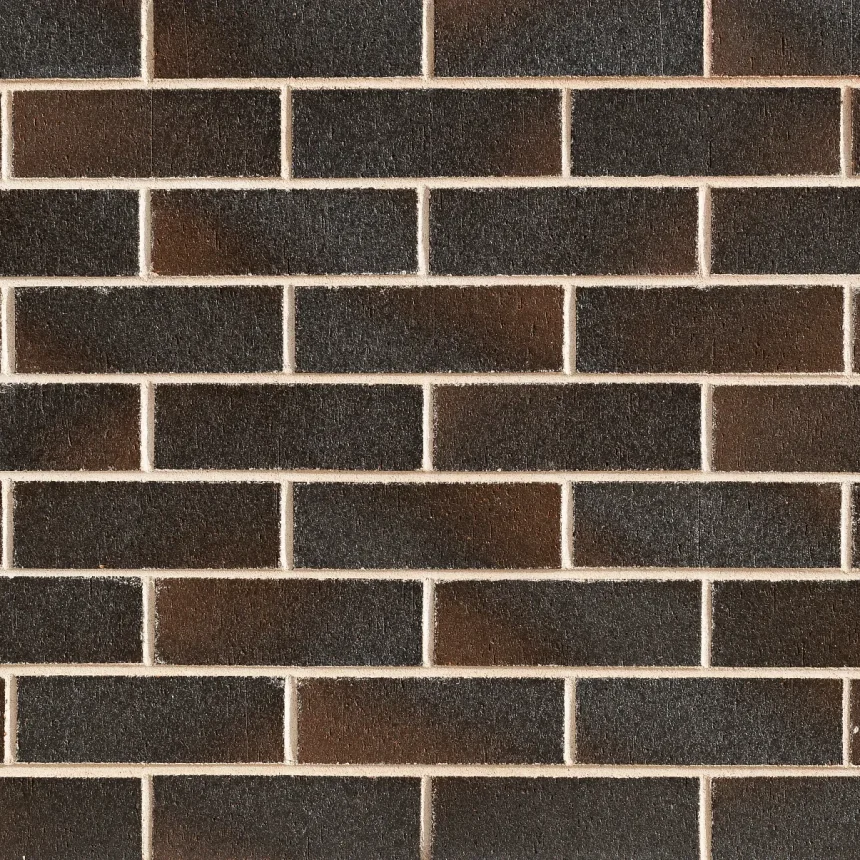 A close-up view showcases a Stratos Dark Cumulus brick wall arranged in a regular pattern. The bricks possess a rough texture reminiscent of Cumulus clouds and are highlighted by light-colored mortar, forming a grid-like design.