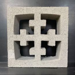 Breeze Block Cross White showcasing a decorative cutout pattern with a central cross and four smaller corner crosses, all against a grey backdrop.