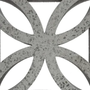 A close-up of GB Breeze Blocks Flower Nickel shows its geometric cut-out pattern with curved shapes and a rough texture, displayed against a white background.