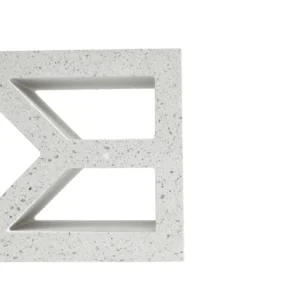 A close-up of a GB Breeze Blocks Diamond Porcelain white concrete block with geometric cutouts, including triangle and diamond shapes, is shown against a plain white background. Only the left portion of the block is visible.