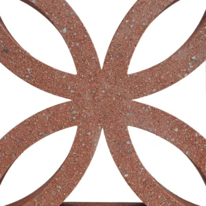 A close-up of a GB Breeze Blocks Flower Pottery terracotta brick featuring a geometric cut-out pattern, showcasing symmetrical shapes and negative space against a white background.