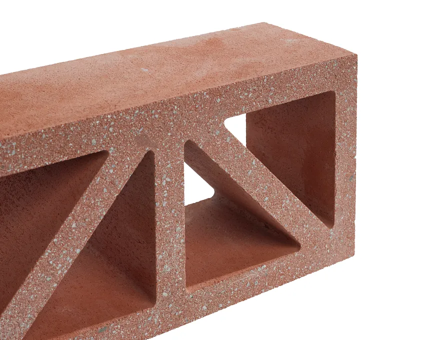 A GB Breeze Blocks Wedge Nickel, a red trapezoidal hollow brick with three large triangular and rectangular openings, is displayed against a white background.