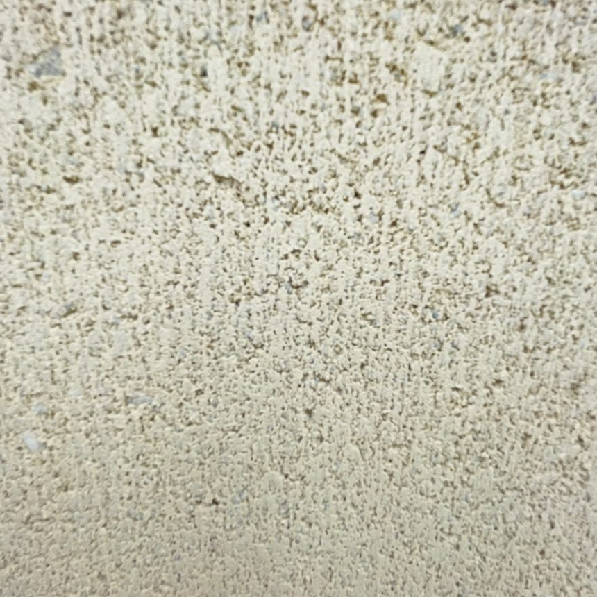 A close-up view of a textured off-white stucco wall surface reveals small bumps and rough patches, contrasting beautifully with the Smooth Face Appin Stone.
