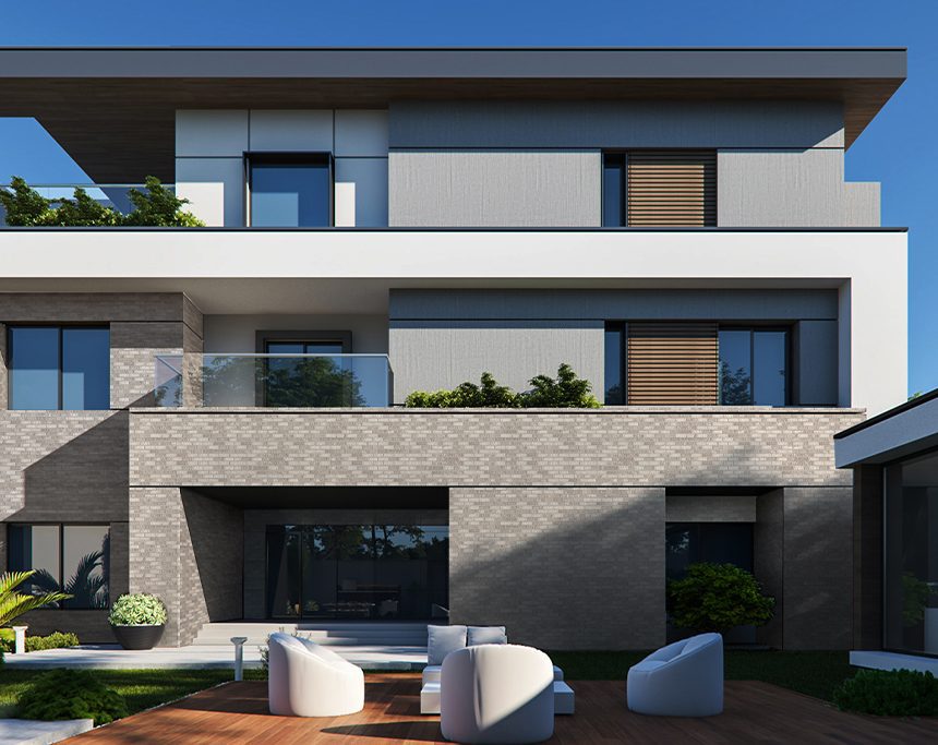 Introducing the Slim New Ash, a modern multi-story home that blends sleek design elements with expansive windows. It features a combination of ash-grey bricks and white panels for a contemporary look. The balcony and patio are equipped with glass railings, complemented by white outdoor furniture, all set amidst lush greenery under a clear blue sky.