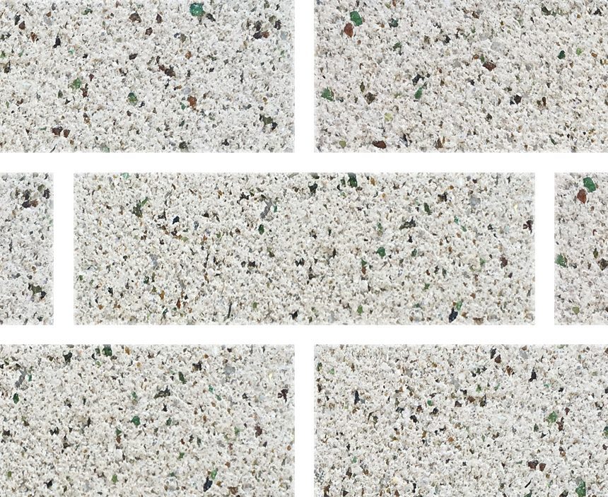 The Exposed Mist ECO tiles create a mosaic-style image featuring light speckled tiles with irregular edges. They are arranged in a staggered pattern and each tile showcases a mix of small, multicolored specks on a white background.