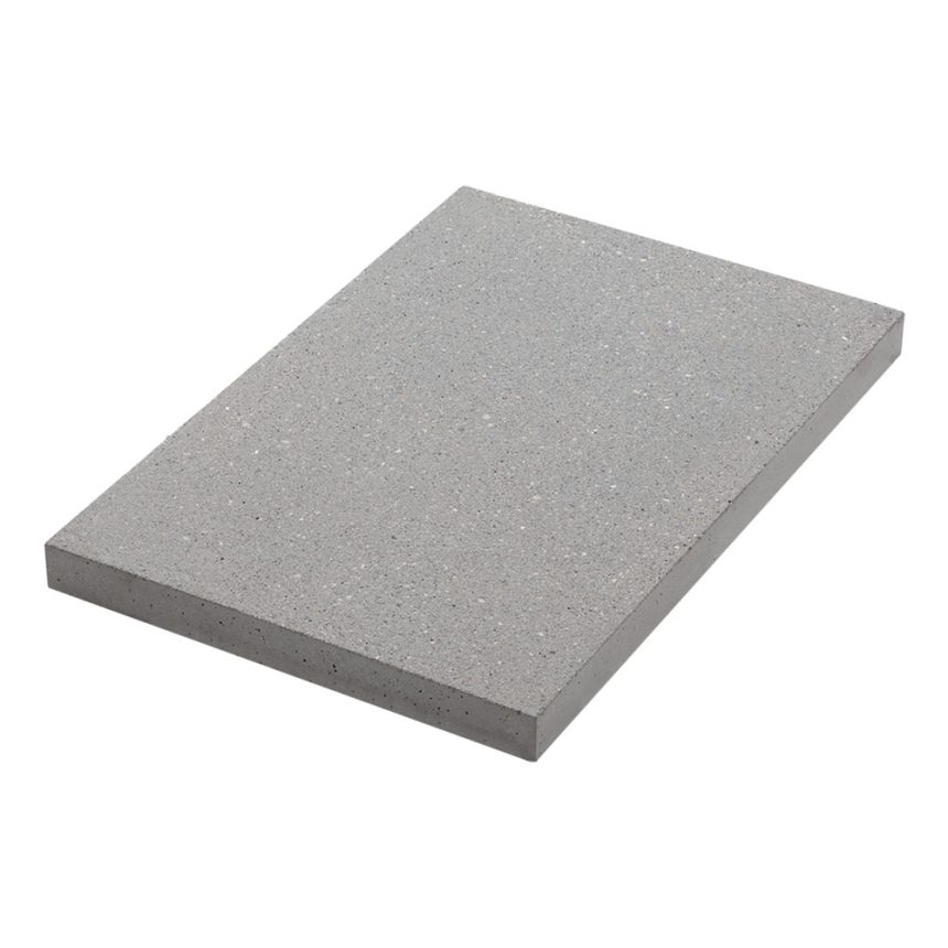 A rectangular Coralstone 600 Shark slab, featuring a smooth, speckled surface, is positioned at a slight angle against a plain, white background, showcasing the sleek elegance of the series.