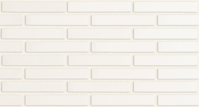 A detailed look at the Morada Linear Blanco reveals a white brick wall with a rectangular, horizontal design. The bricks feature a smooth and consistent surface, offering a sleek and minimalist look.