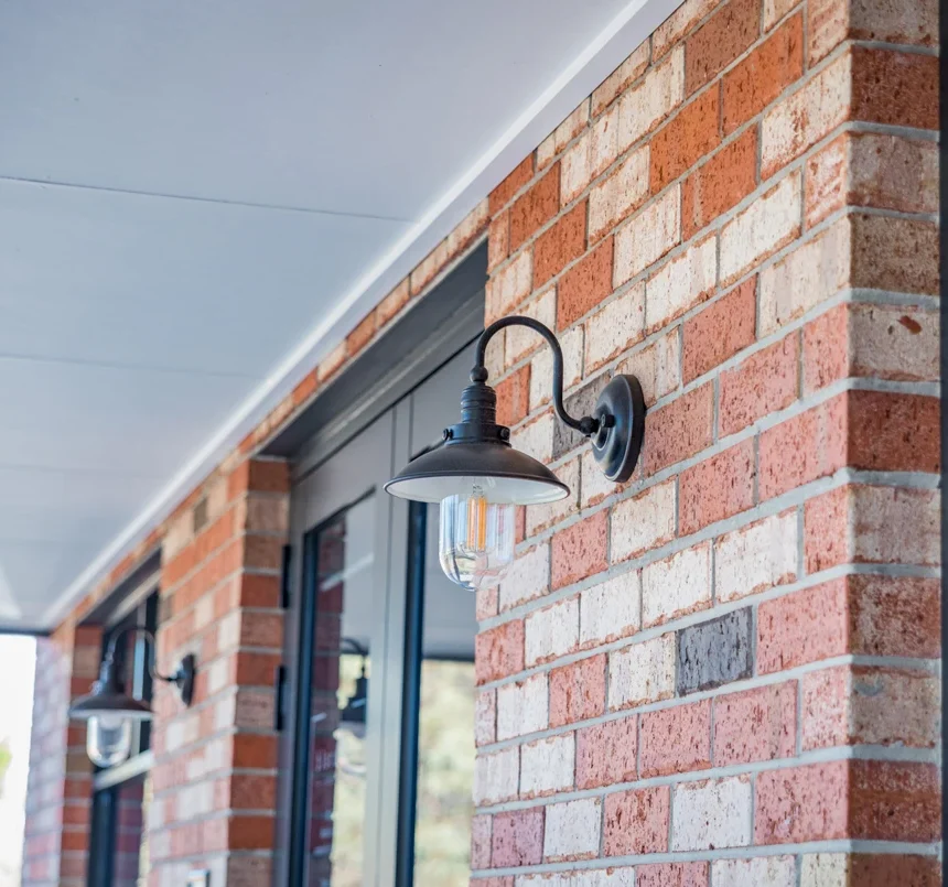 A close up of a brick wall of a house using McLaren Vale Bricks from Littlehampton Bricks and Pavers. The bricks are a range of colours from red, cream, black and blue with more of the red brick than any other colour in the mix.