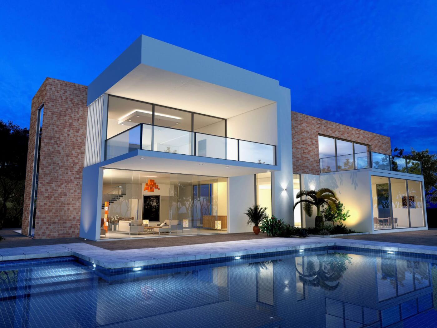 Modern two-story house with large glass windows, brick and white exterior, and a lit interior. It features a spacious balcony and overlooks a reflective swimming pool. Surrounded by trees, the house is set against a twilight sky.