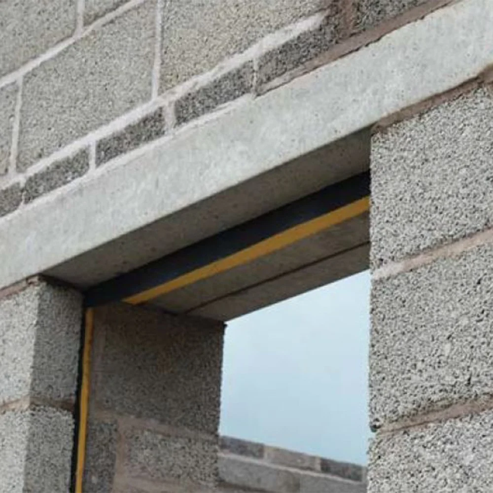 A concrete block wall with an unfinished doorway featuring a concrete lintel. The lintel, complements the grey bricks with their visible texture. Fibre cement accents add durability, and the sky is faintly visible through the opening.
