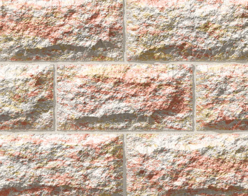 A close-up of a textured brick wall shows the rough surface and varied pink, beige, and light yellow tones of GB Sandstone Rockface Endeavour Blend (Copy), with thin gray mortar lines highlighting each uneven brick.