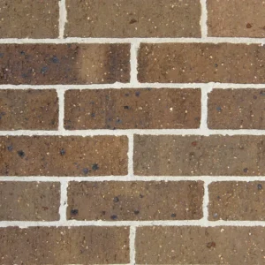 A close-up view of a brown brick wall with light-colored mortar between the bricks, featuring a regular horizontal and staggered pattern, typical of Hawthorn 76 Cambridge style.