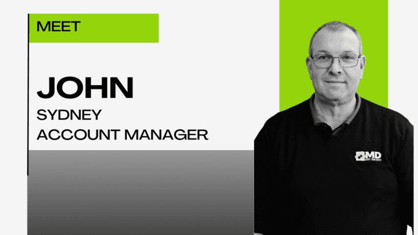 A man wearing glasses and a black shirt with an MD logo stands on the right. Text on the left reads, Meet John Kirovski, Sydney Account Manager. The background is white with green and gray accents.