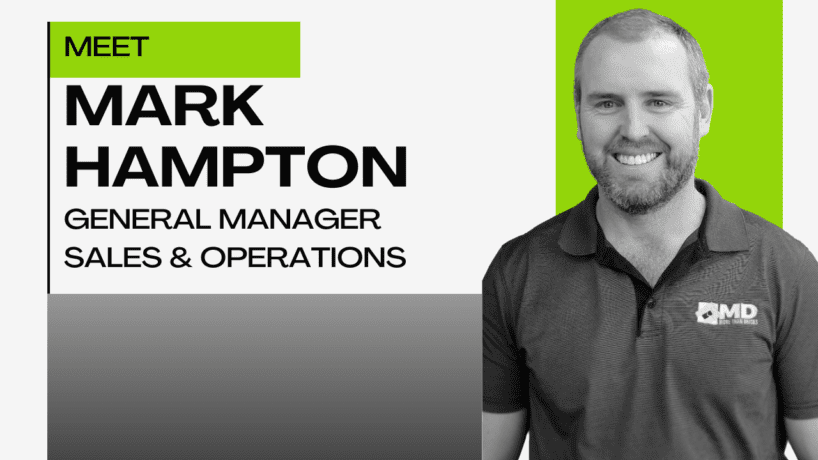 A promotional graphic introducing Mark Hampton, General Manager of Sales & Operations. He is smiling, wearing a polo shirt with the MD logo, and stands beside bold text on a white and green background.