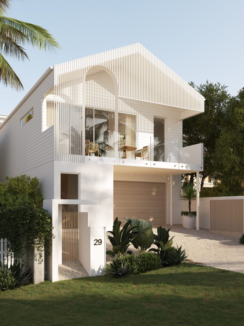 Modern white two-story house with large windows, a covered balcony, glass railing, and vertical wooden slats crafted from Innova Fibre Cement; surrounded by lush greenery and featuring a minimalist front yard. House number 29 is visible by the gate.