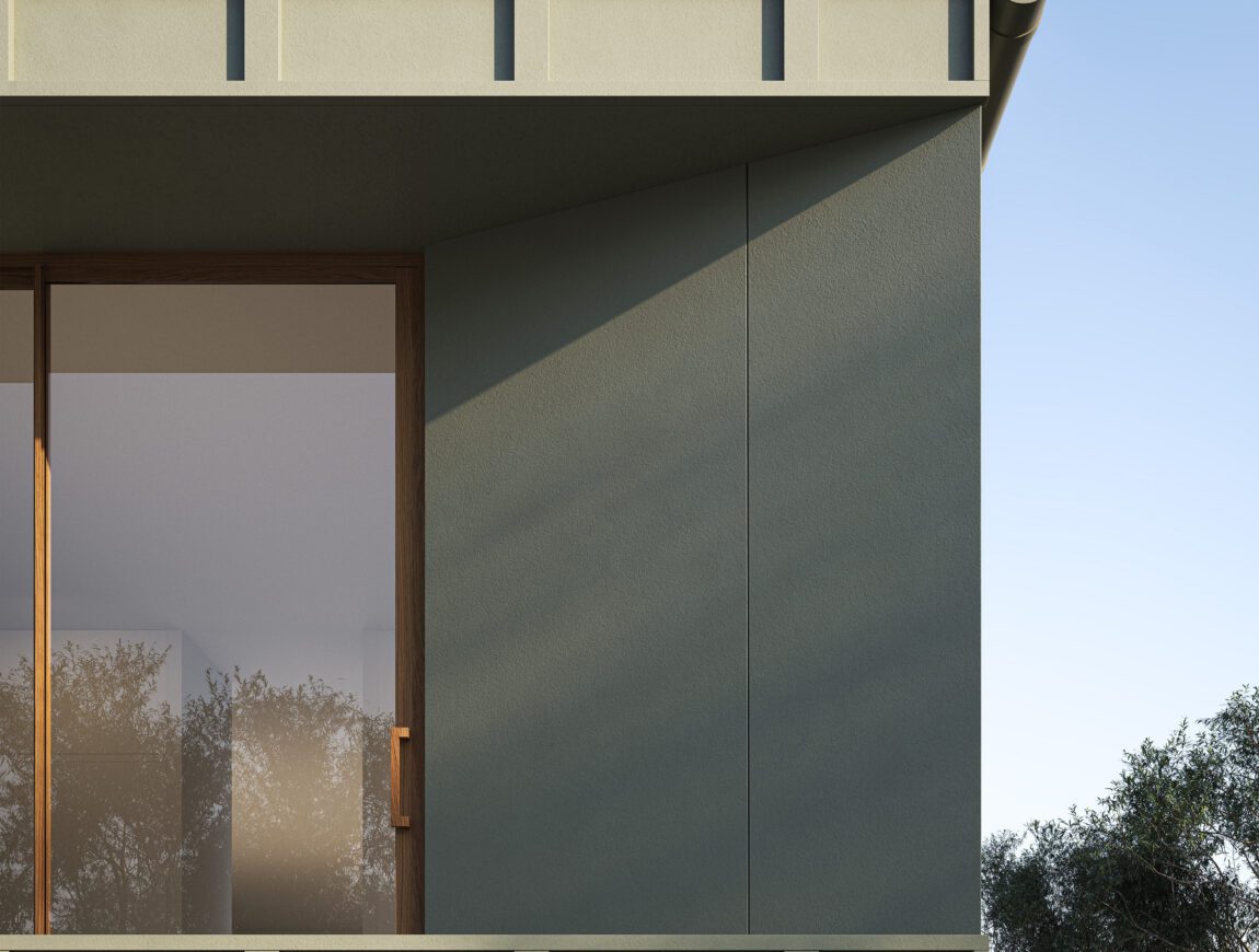 A modern building with sage green Innova Fibre Cement walls, a large glass window with a wooden frame, and shadows of trees reflected on the glass under a clear blue sky.